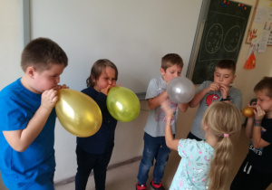 Próba siły - chłopcy dmuchają balony